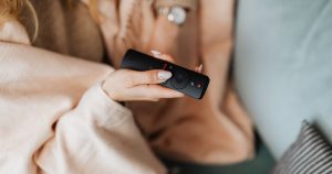 How to choose an IPTV service - holding a TV remote - StreamQ